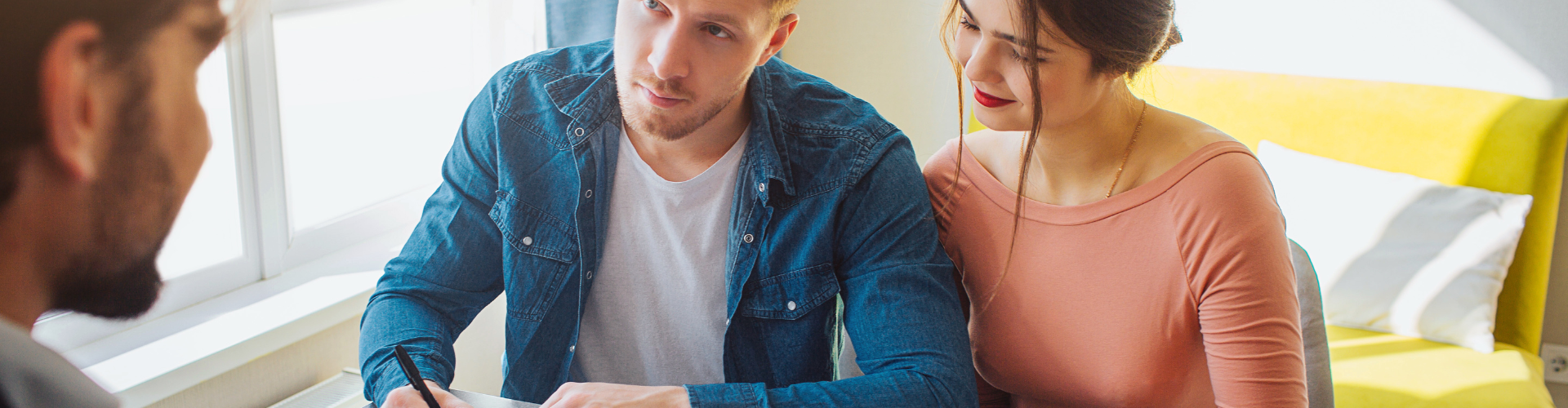 A woman and a man sitting on a couch.