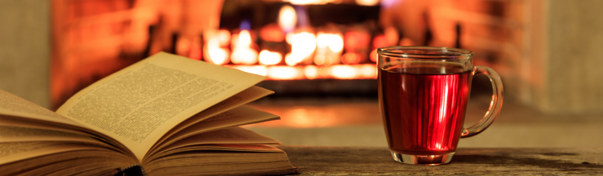 A book and a glass of liquid.