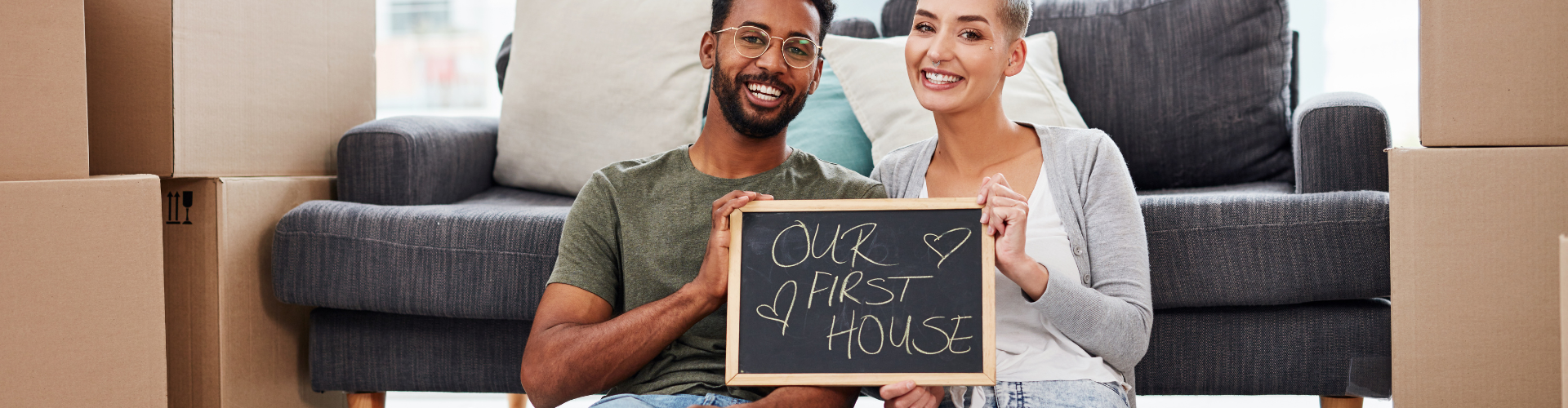 A man and a woman holding a sign.