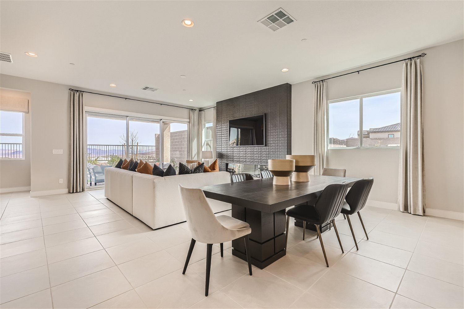 A large living room with a large table and chairs.