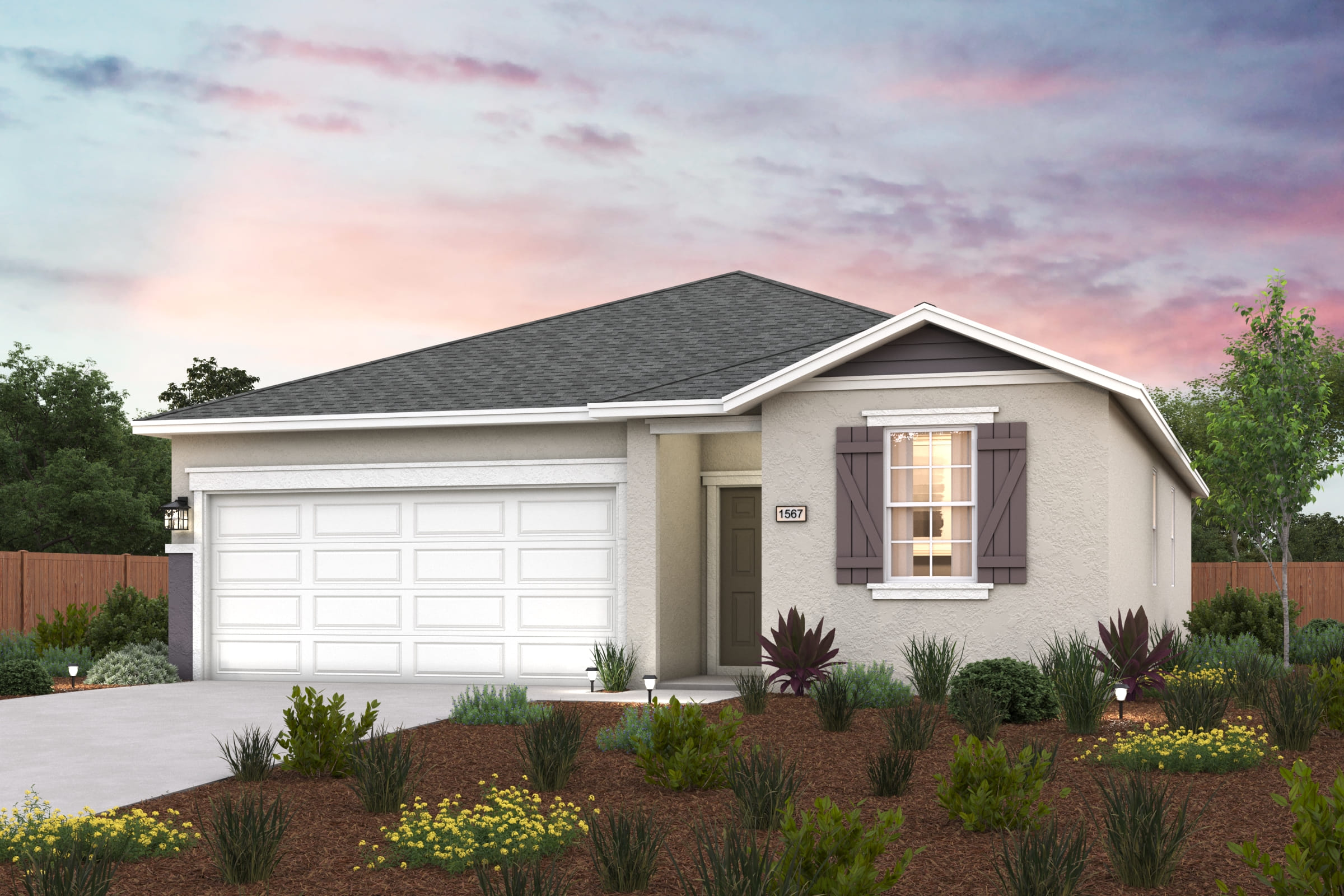 A house with a garage and a garden in front of it.