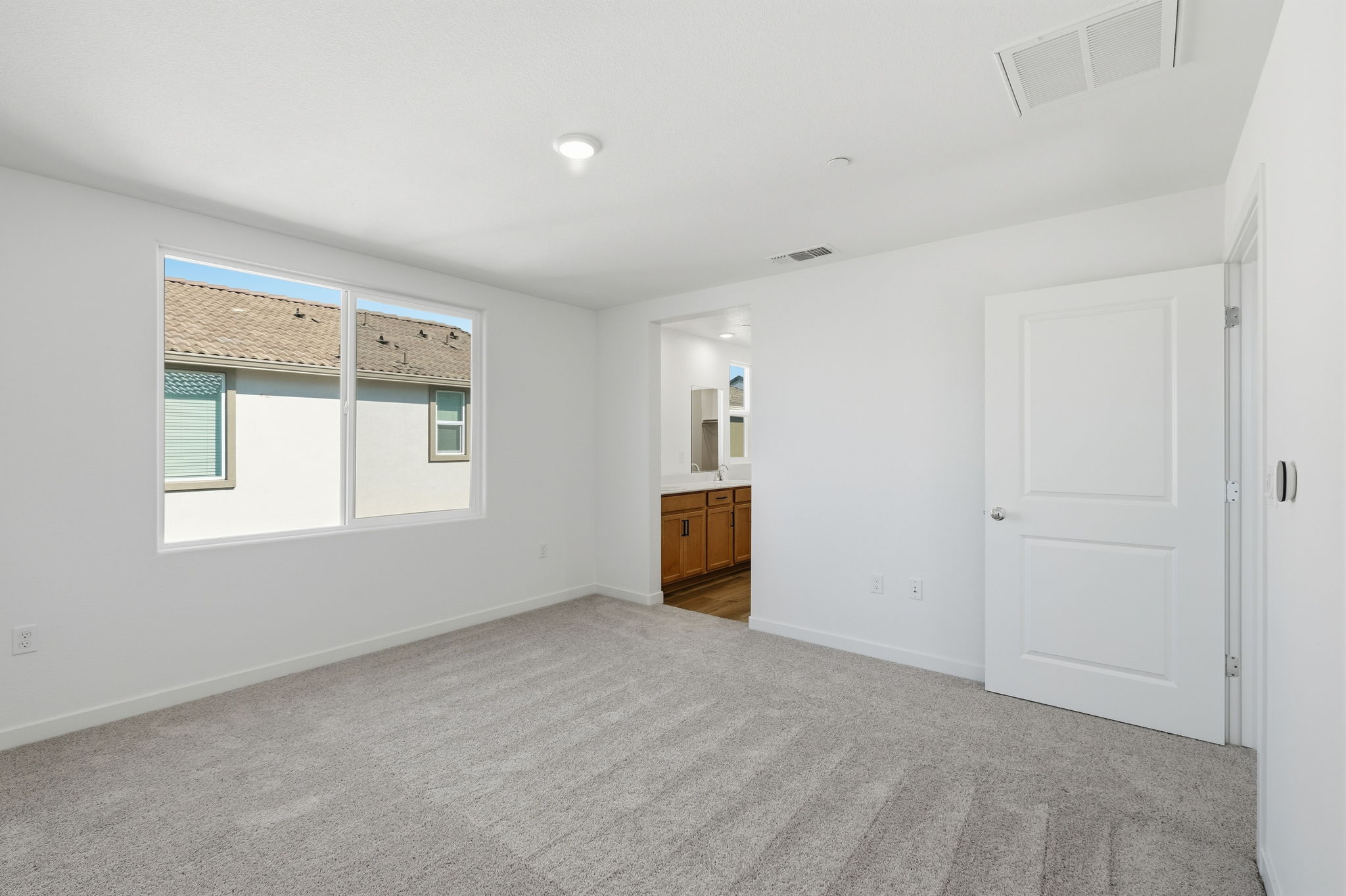 A room with white walls and a window.