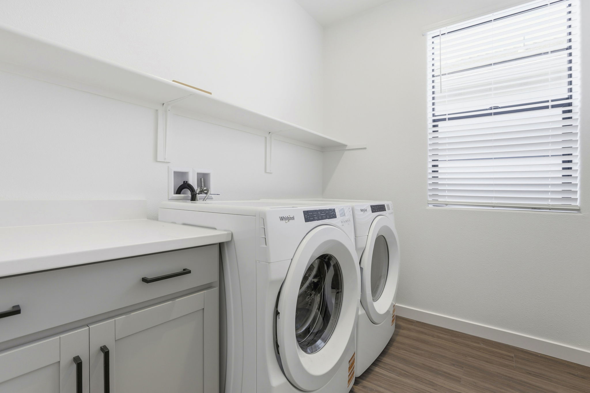 A washing machine in a room.