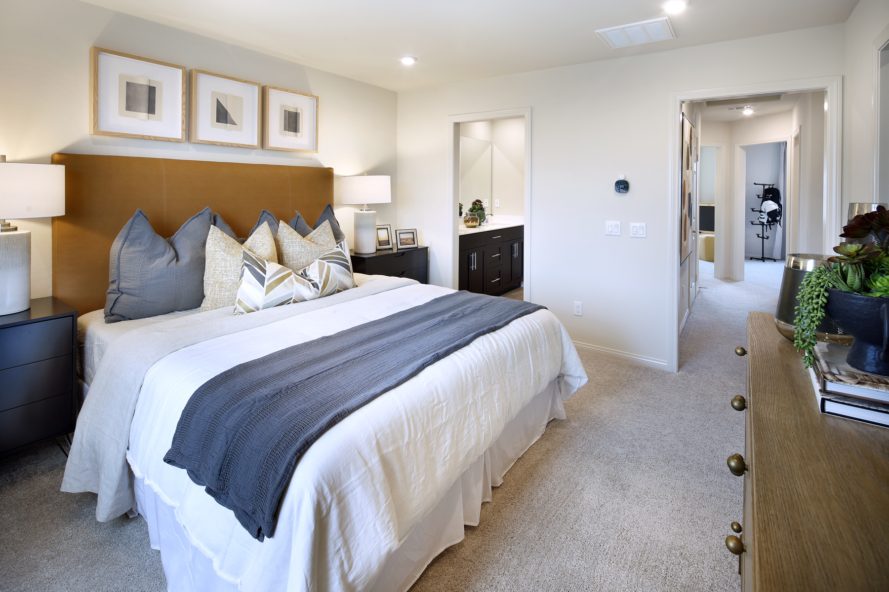 A bedroom with a bed and a mirror.