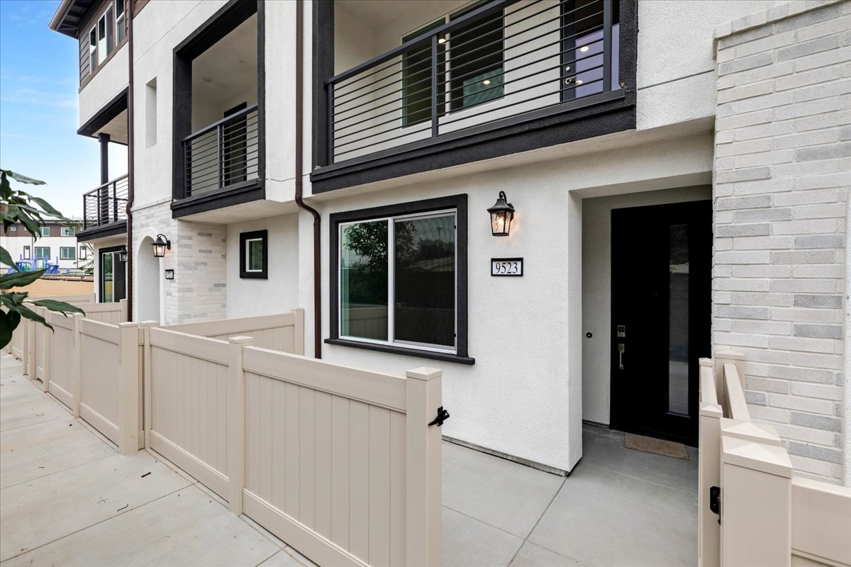 A white building with a white railing.