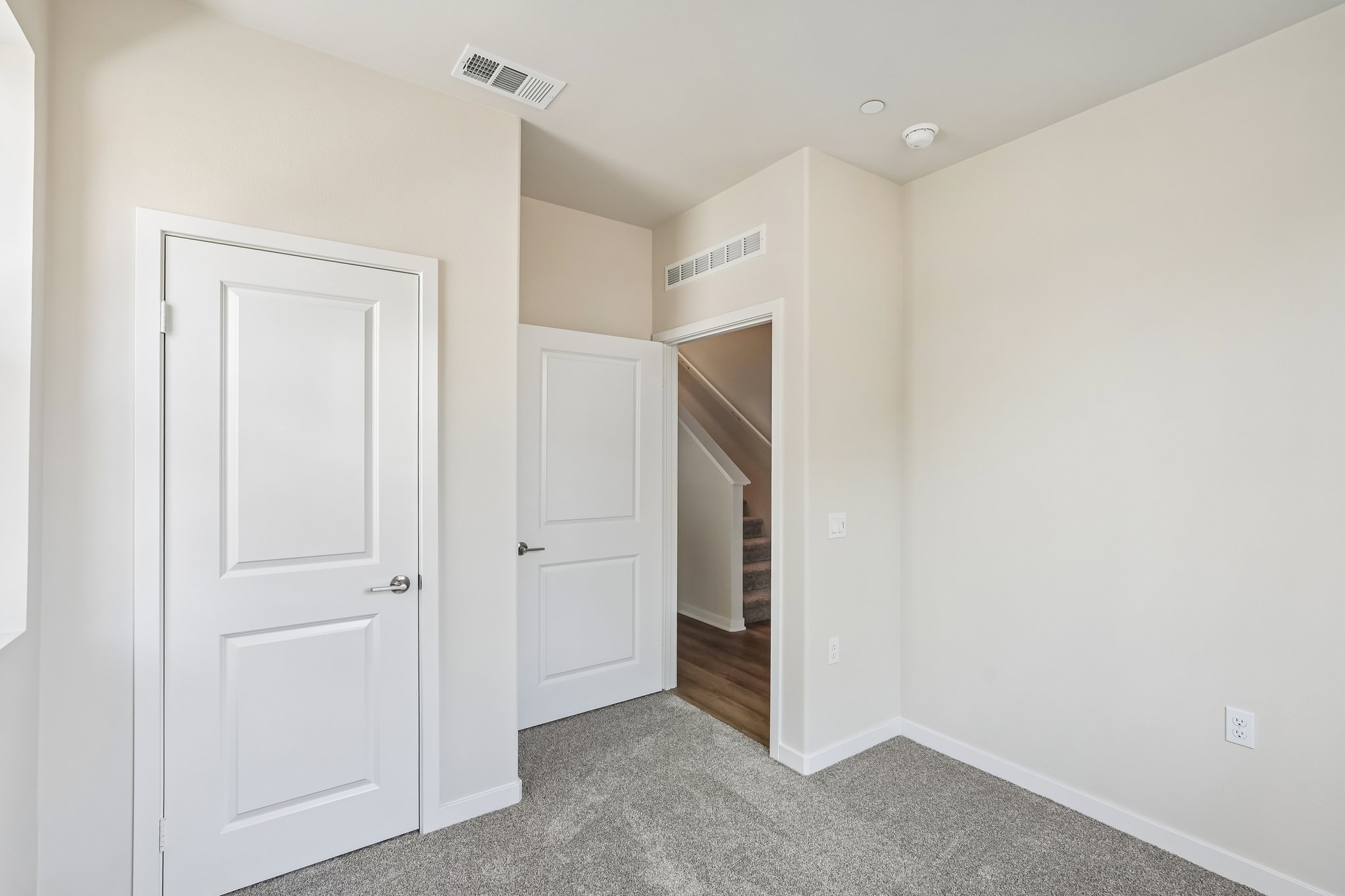 A hallway with white doors.