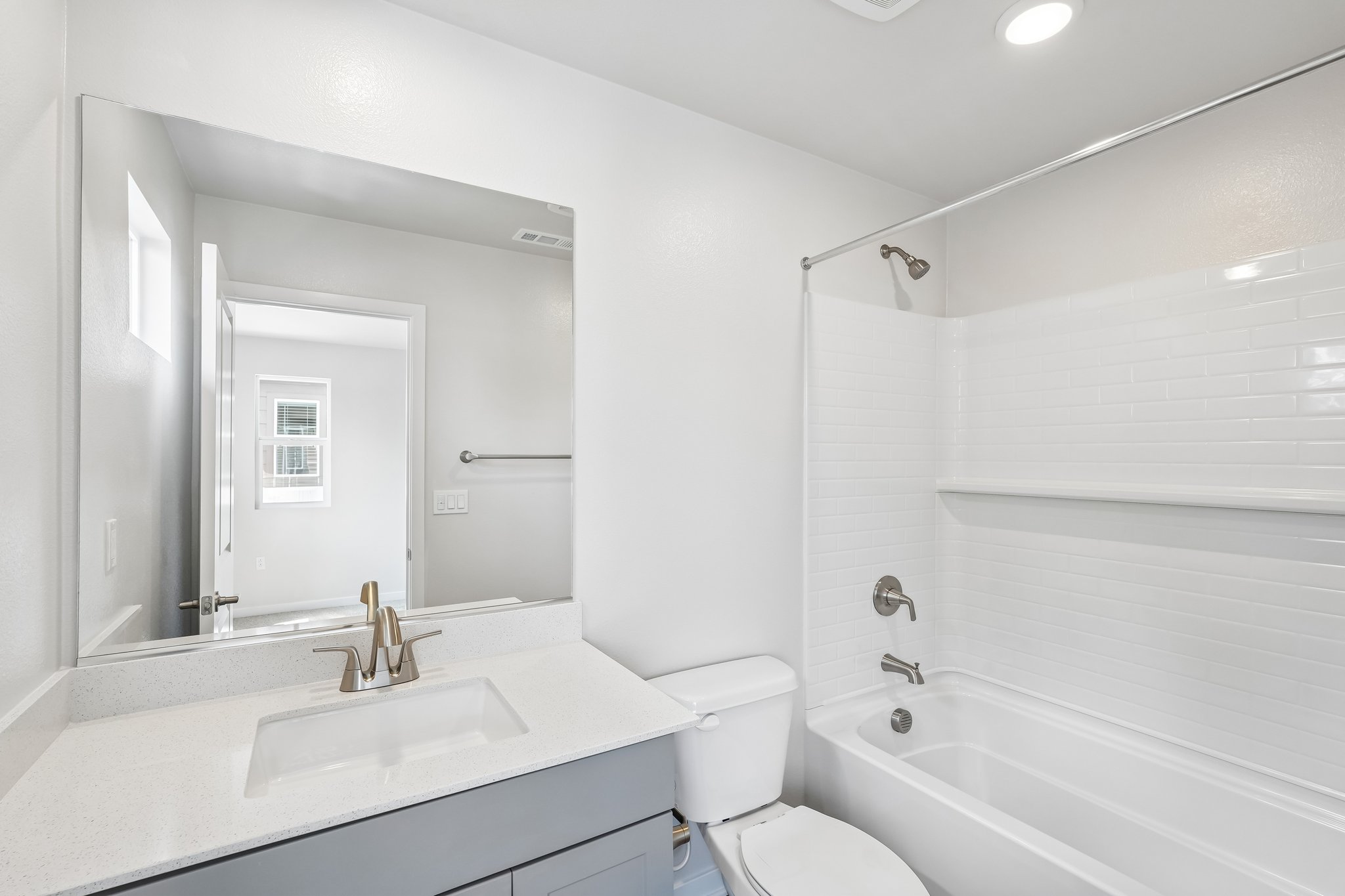 A bathroom with a tub sink and toilet.