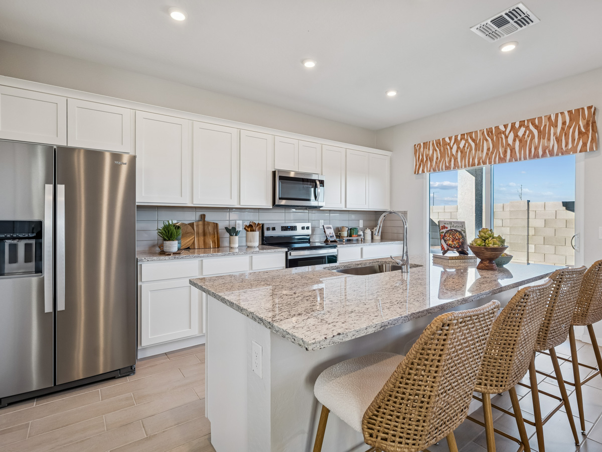 A kitchen with white cabinets.