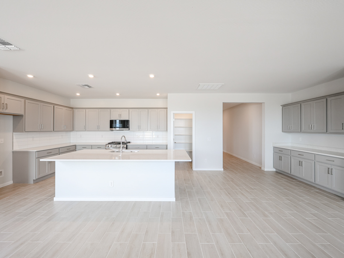A kitchen with white cabinets.