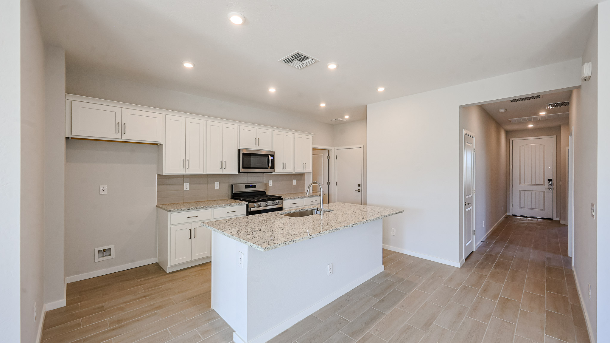 A kitchen with white cabinets.