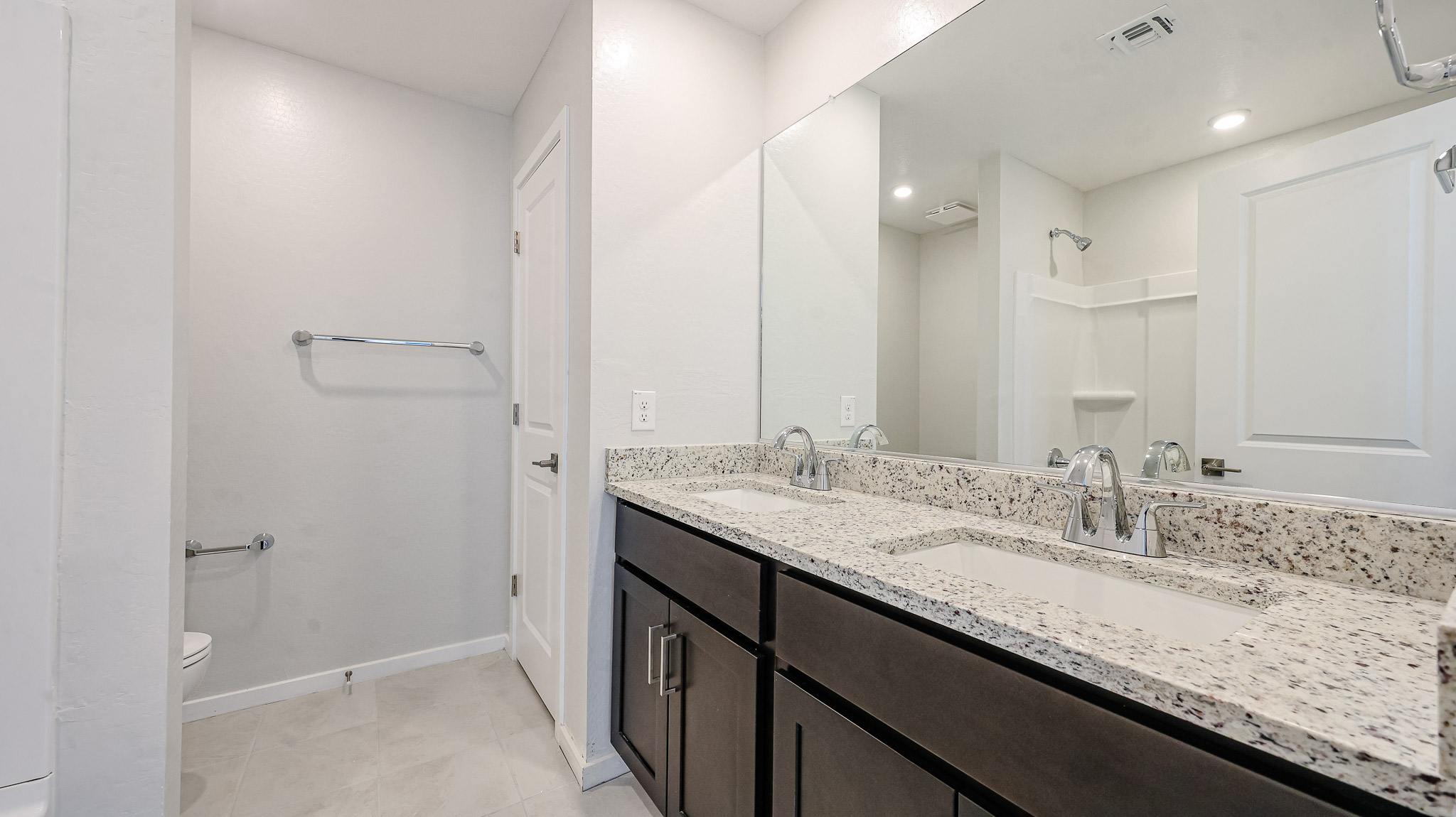 A bathroom with a marble countertop.