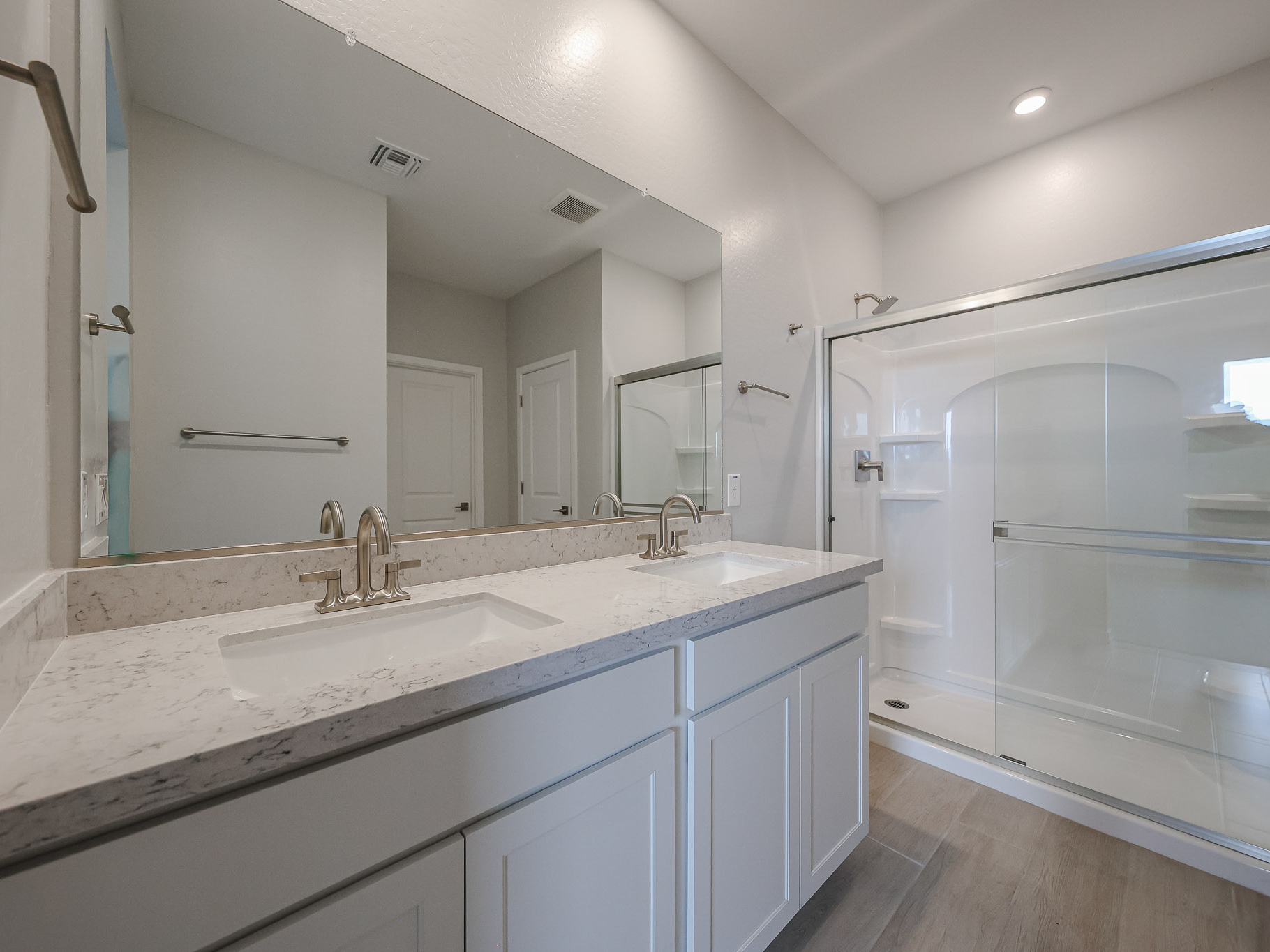 A bathroom with a large mirror.