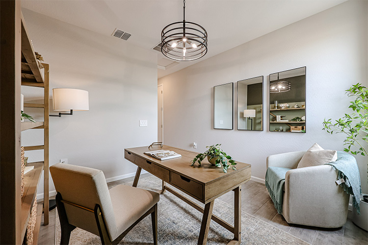 A living room with a table and chairs.