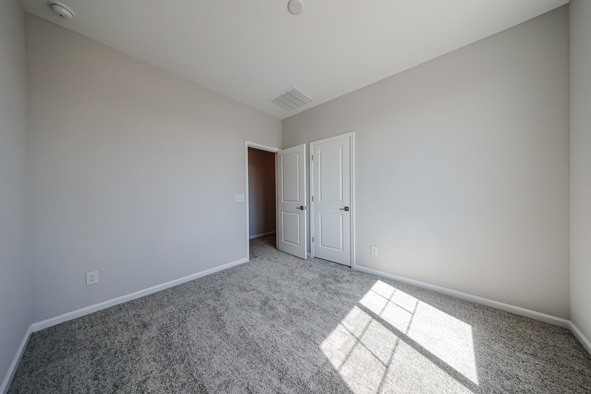 A hallway with white doors.
