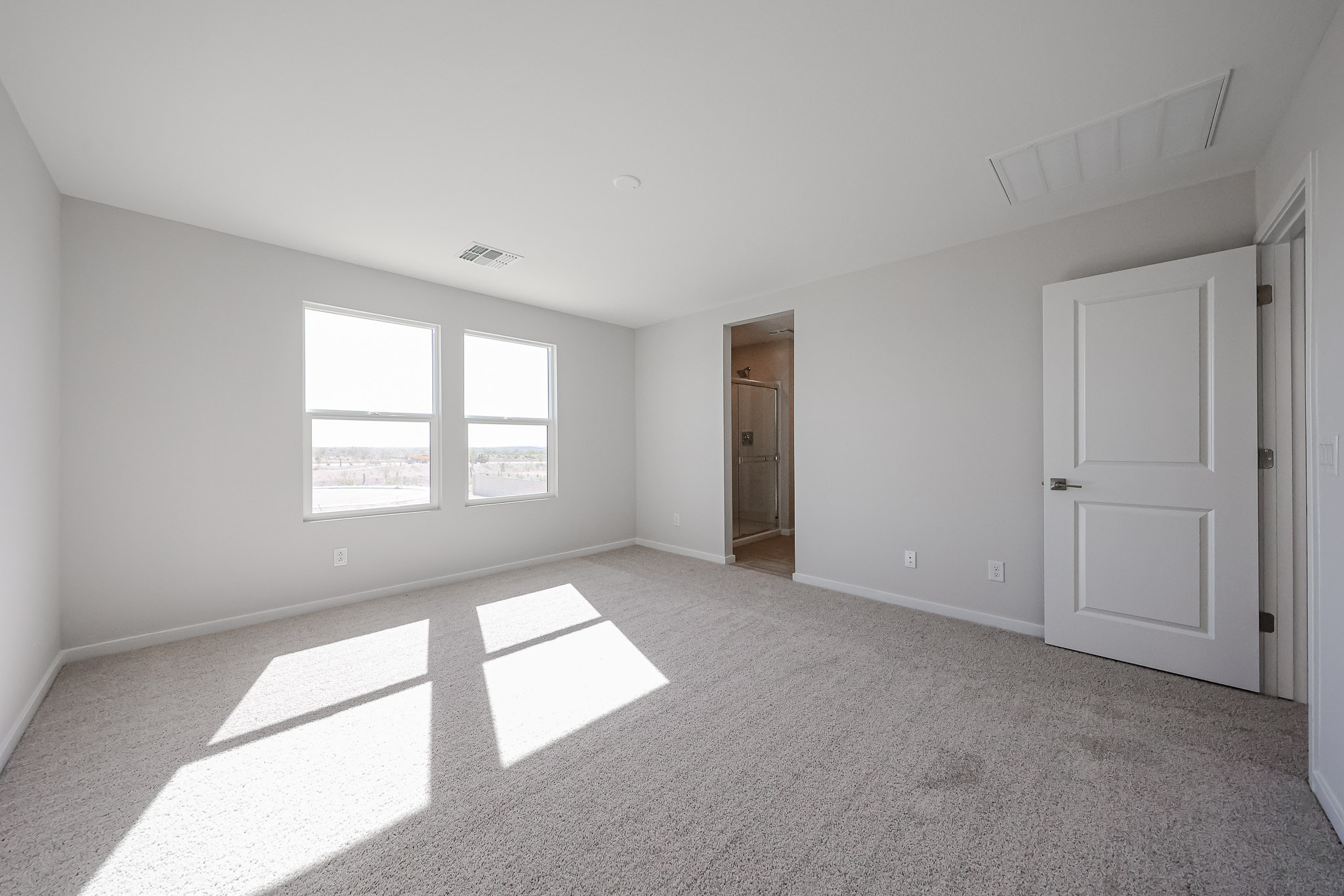 A room with white walls and a door.