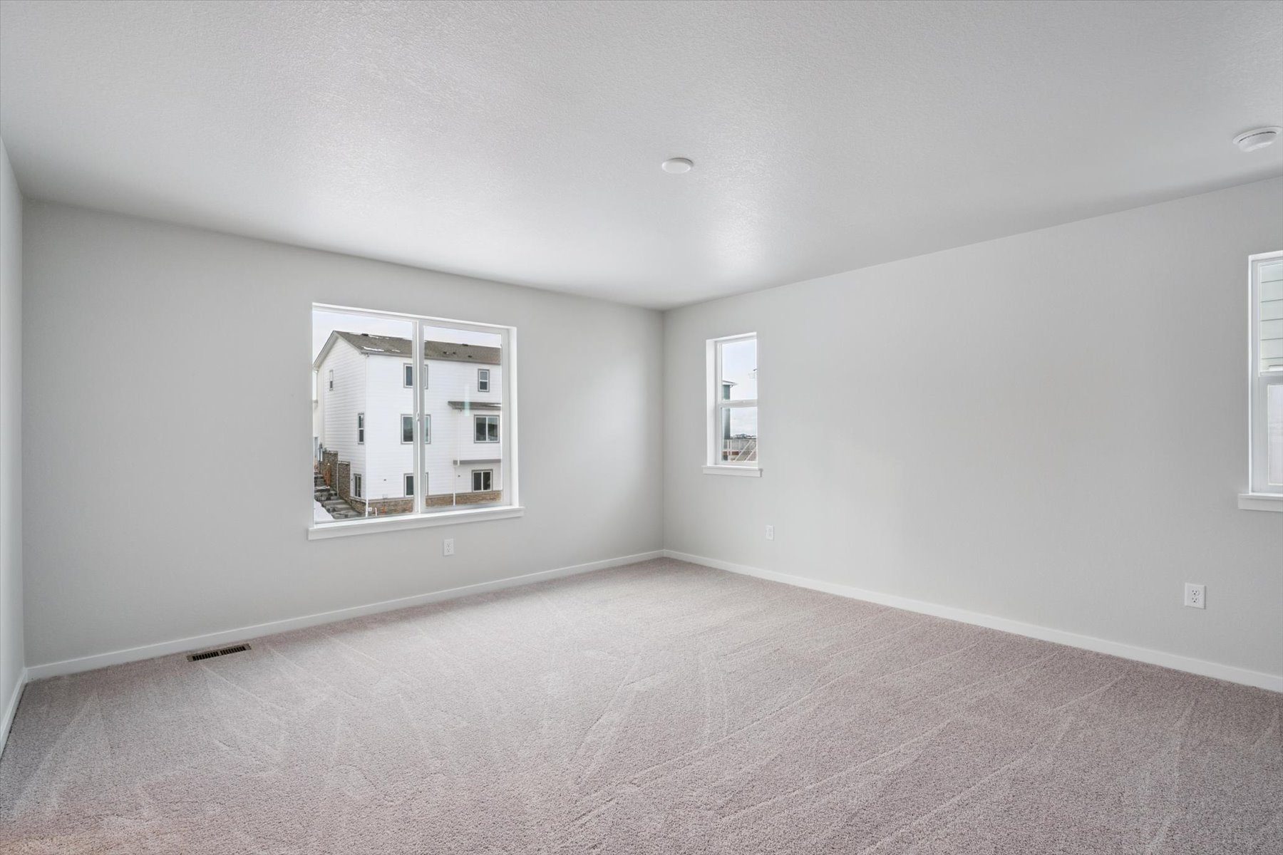 A room with a window and a carpet.