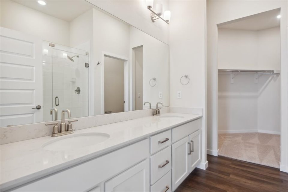 A bathroom with a large mirror.