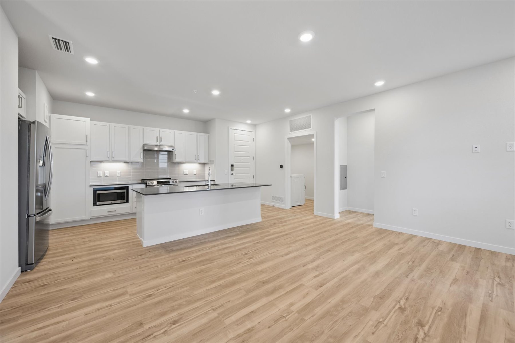 A kitchen with white cabinets.