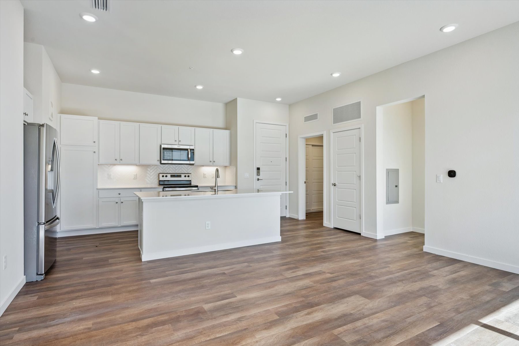 A kitchen with white cabinets.