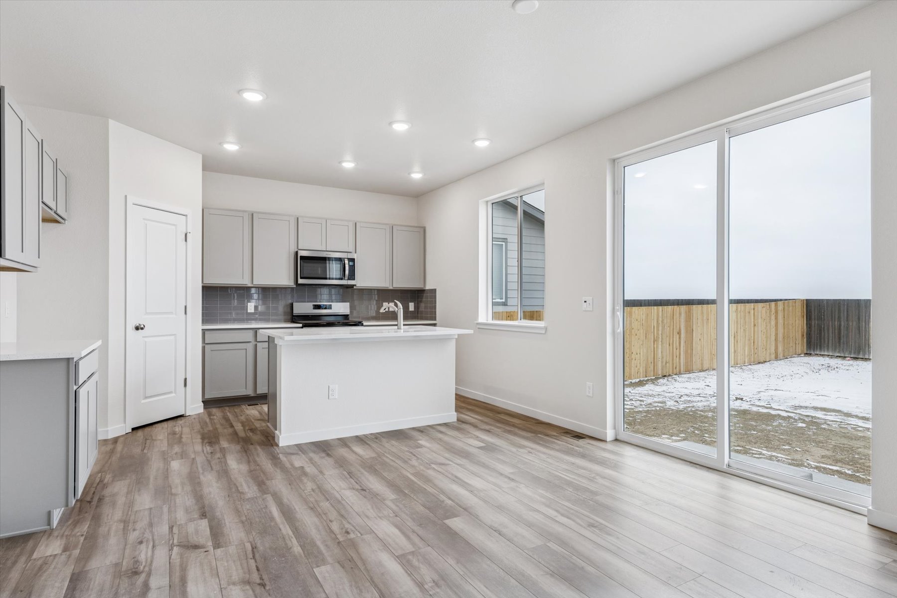 A kitchen with a bed and a window.