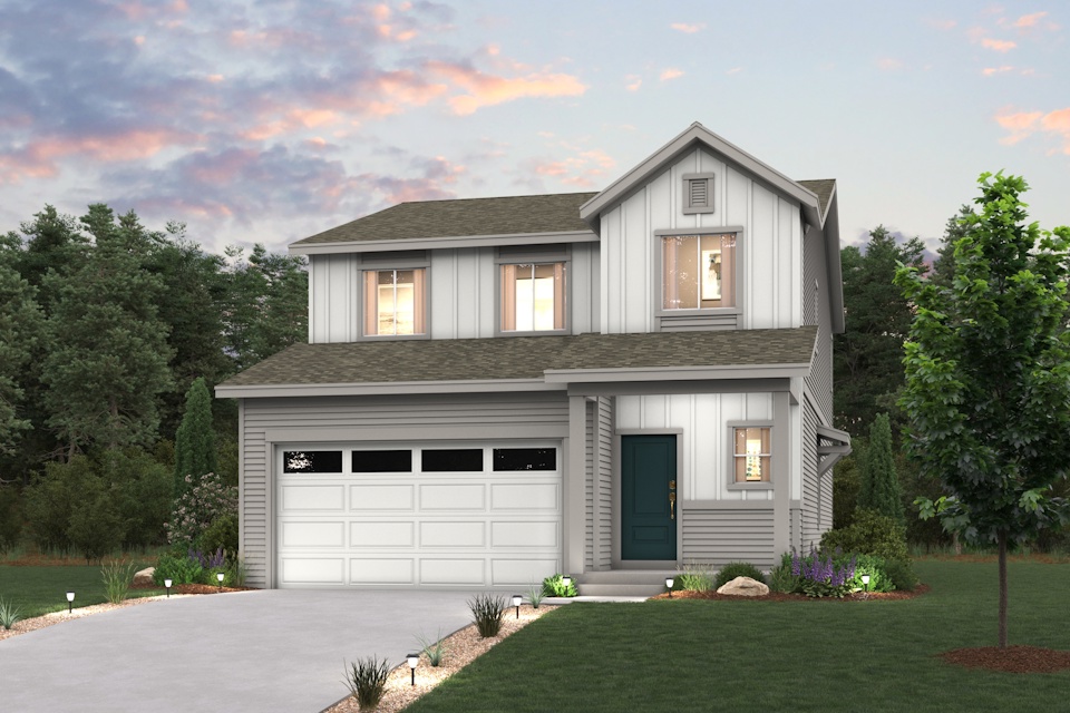 A house with a garage and trees.
