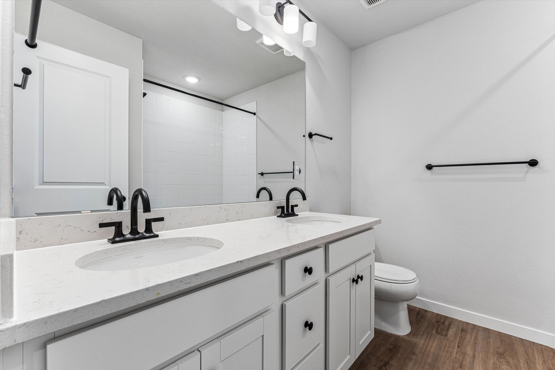 A bathroom with a large mirror.