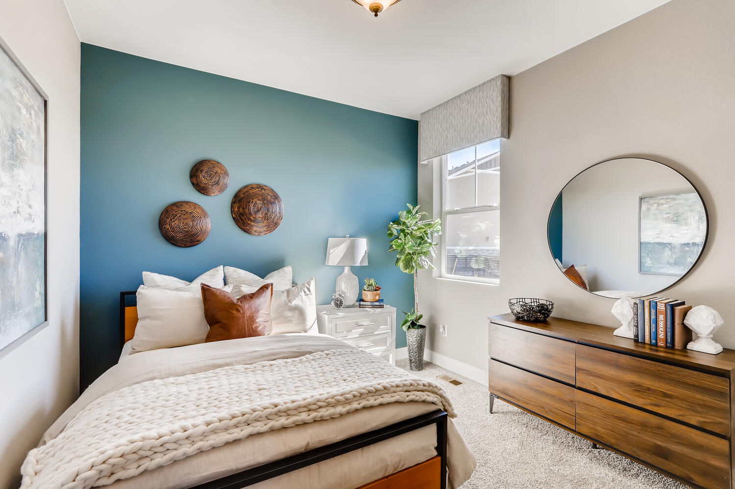 A bedroom with a large mirror.