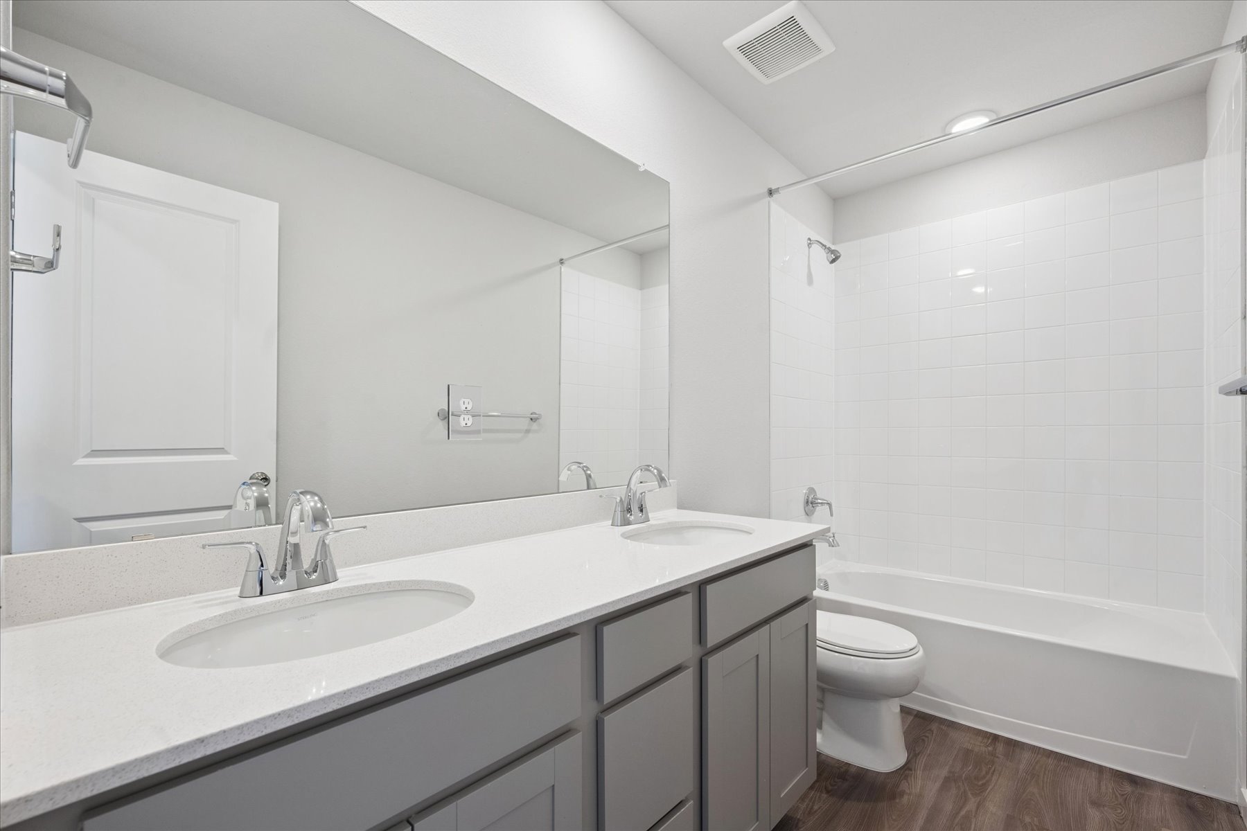 A bathroom with a tub sink and toilet.