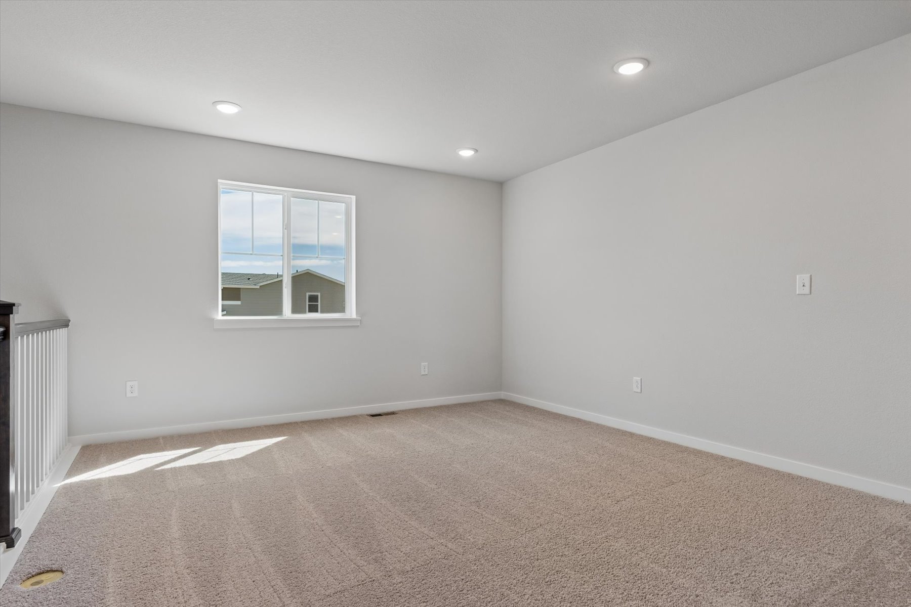 A room with a carpet and a window.