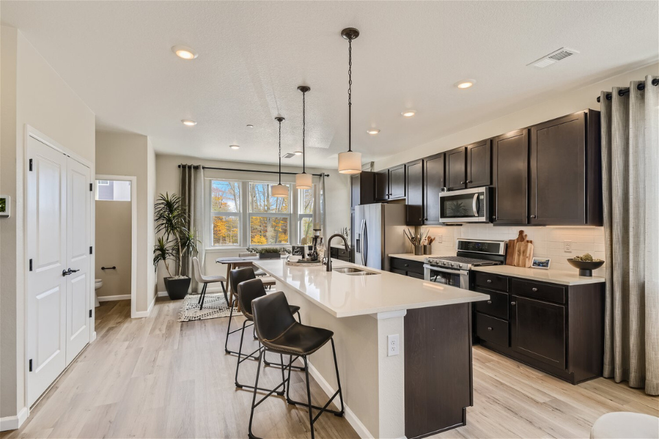 A kitchen with black cabinets.