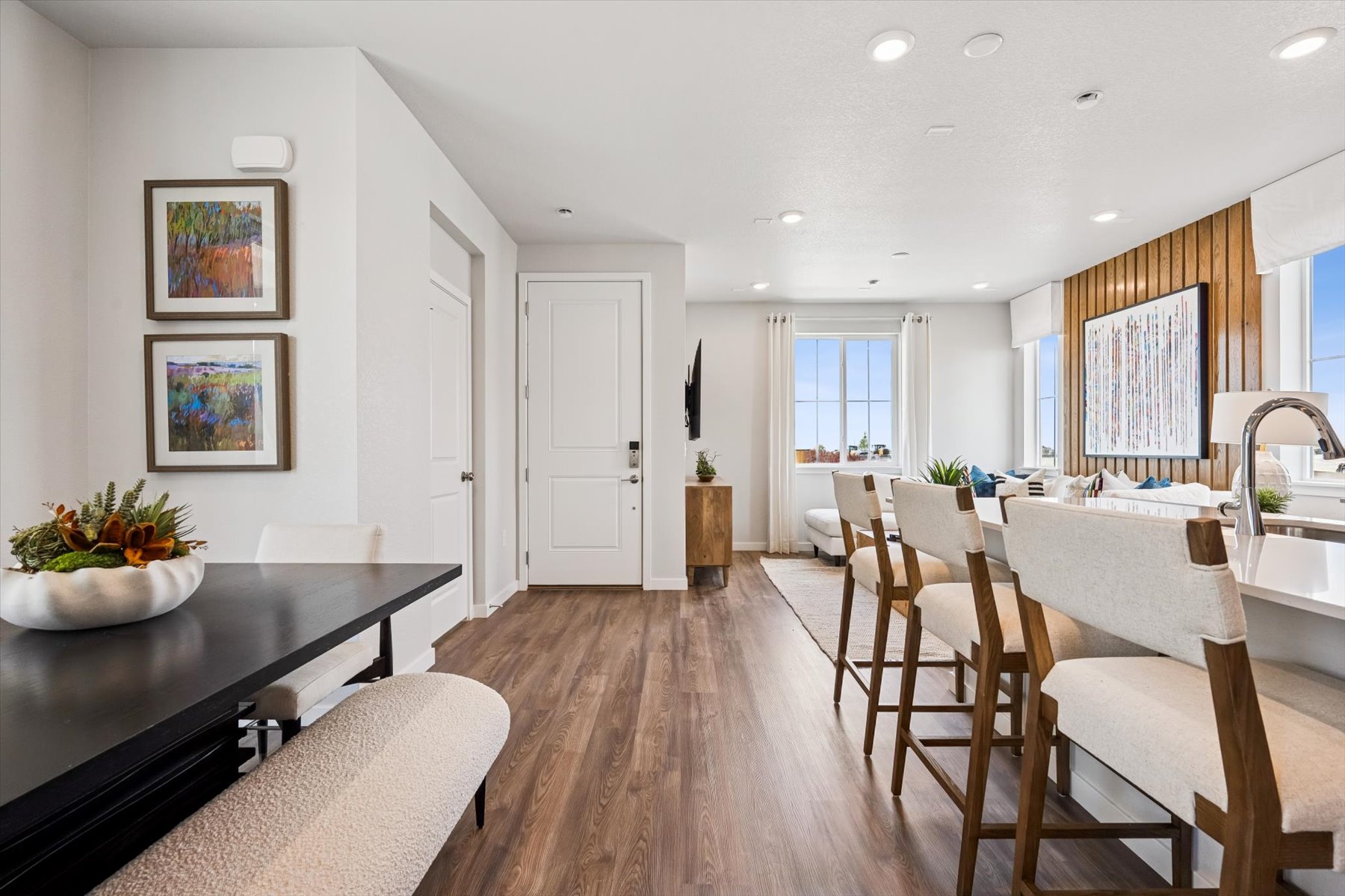 A dining room with a table and chairs.