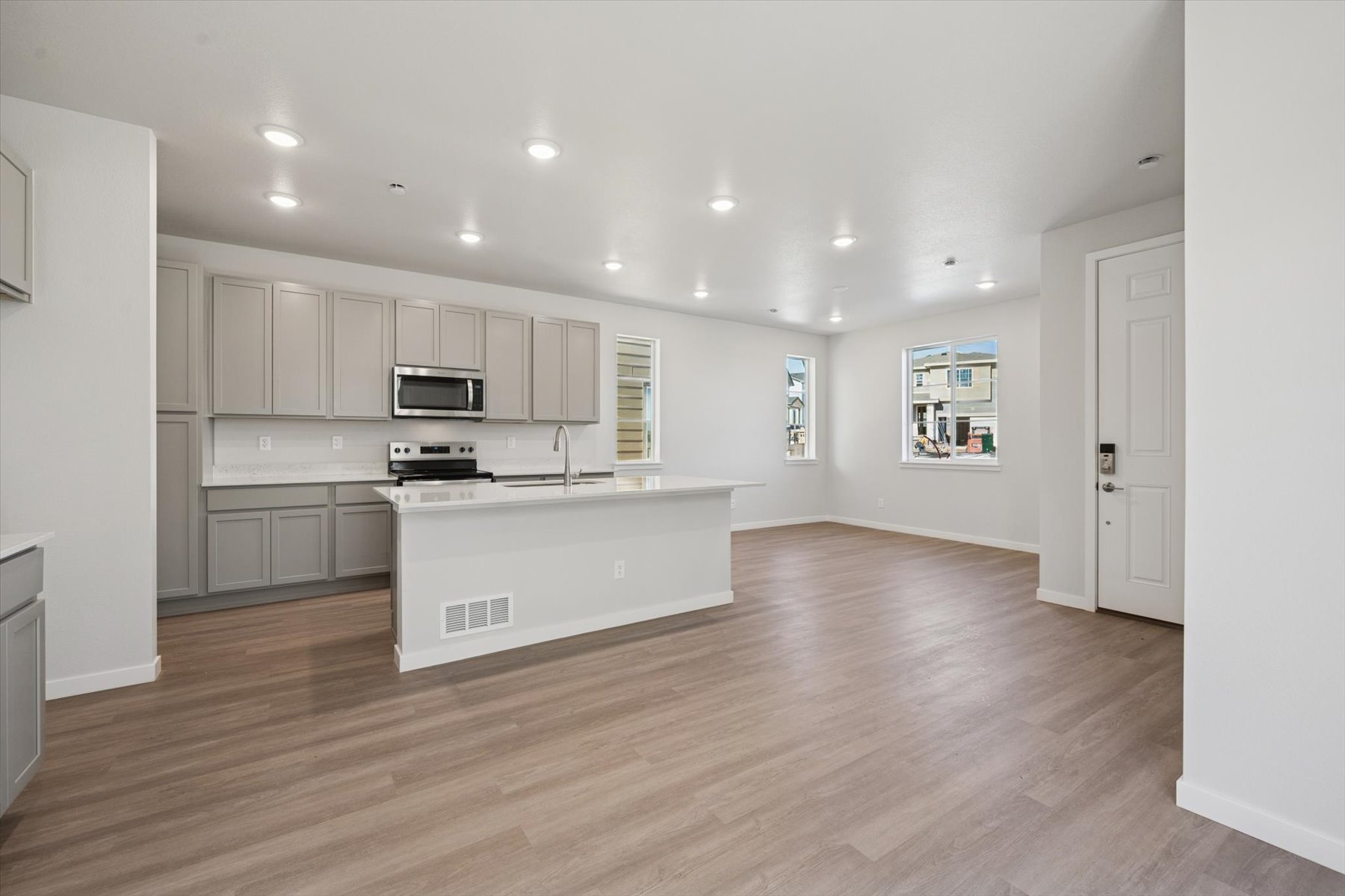 A kitchen with white cabinets.