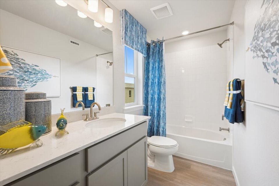A bathroom with a tub sink and toilet.