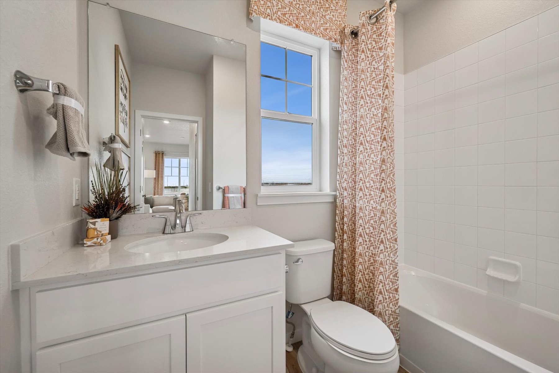 A bathroom with a tub sink and toilet.