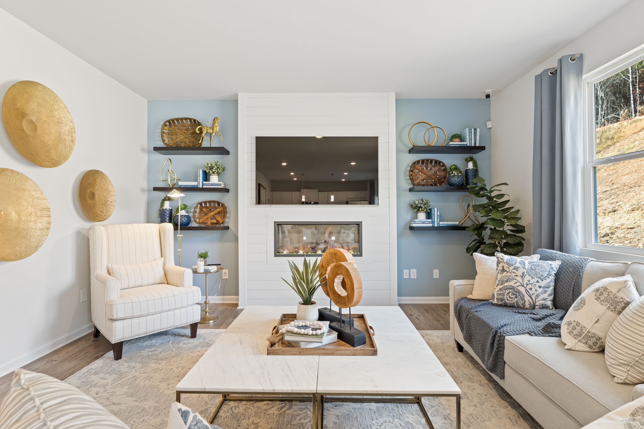 A living room with a table and chairs.
