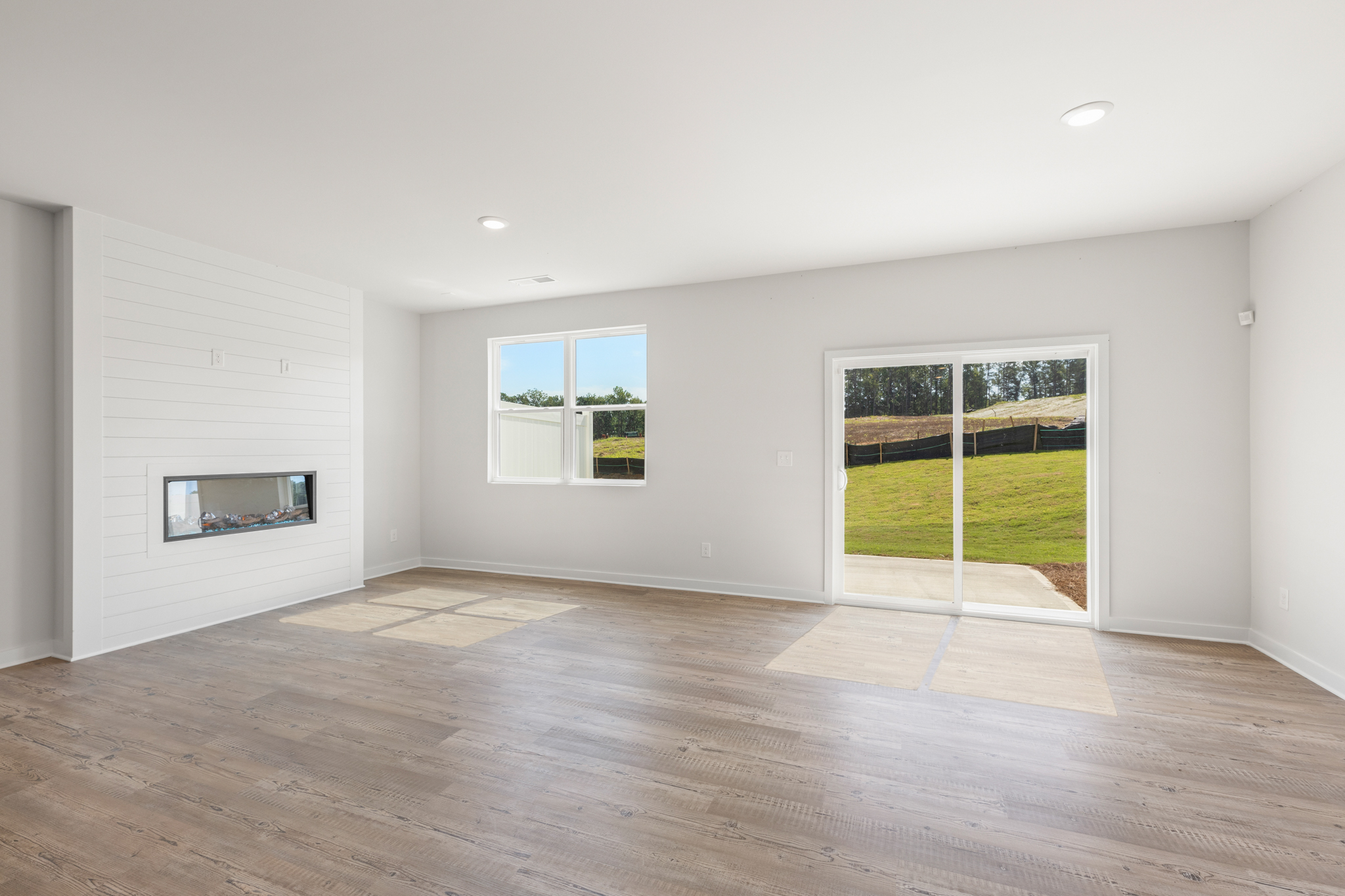 A room with a wood floor and a glass door with a window.