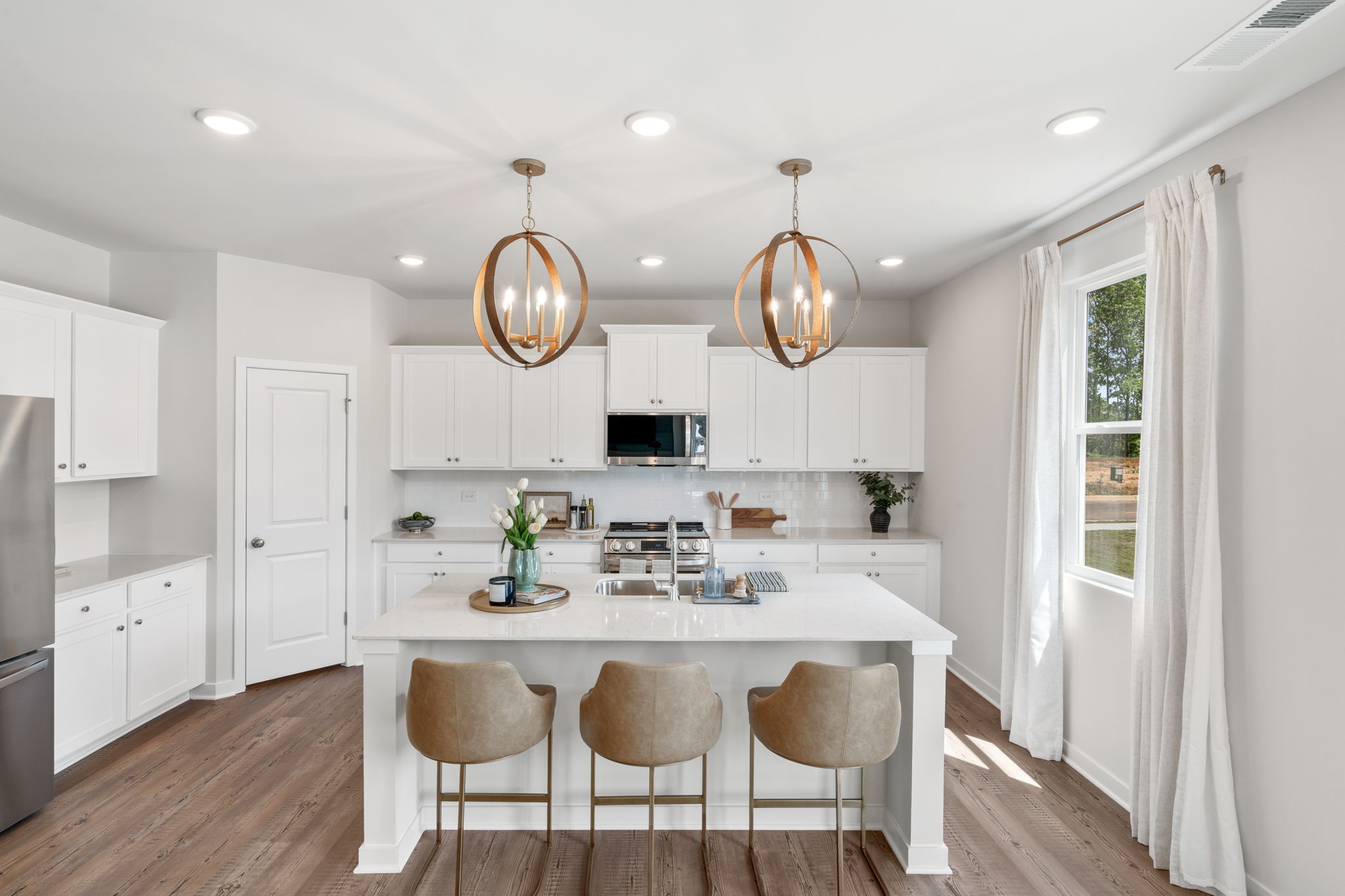 A kitchen with white cabinets.