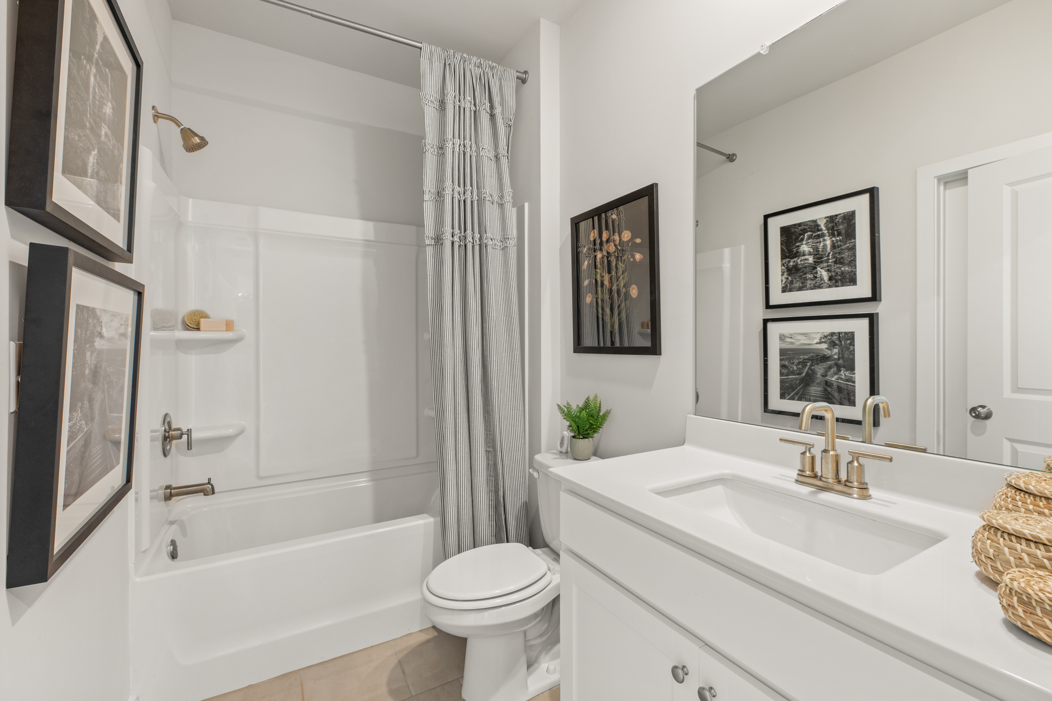 A bathroom with a tub sink and a toilet.