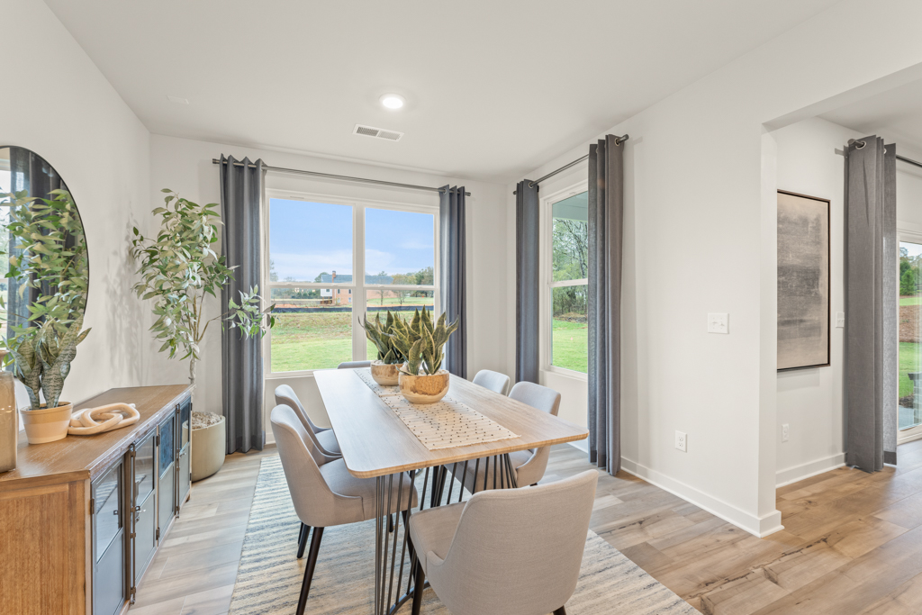 A dining room with a large window.