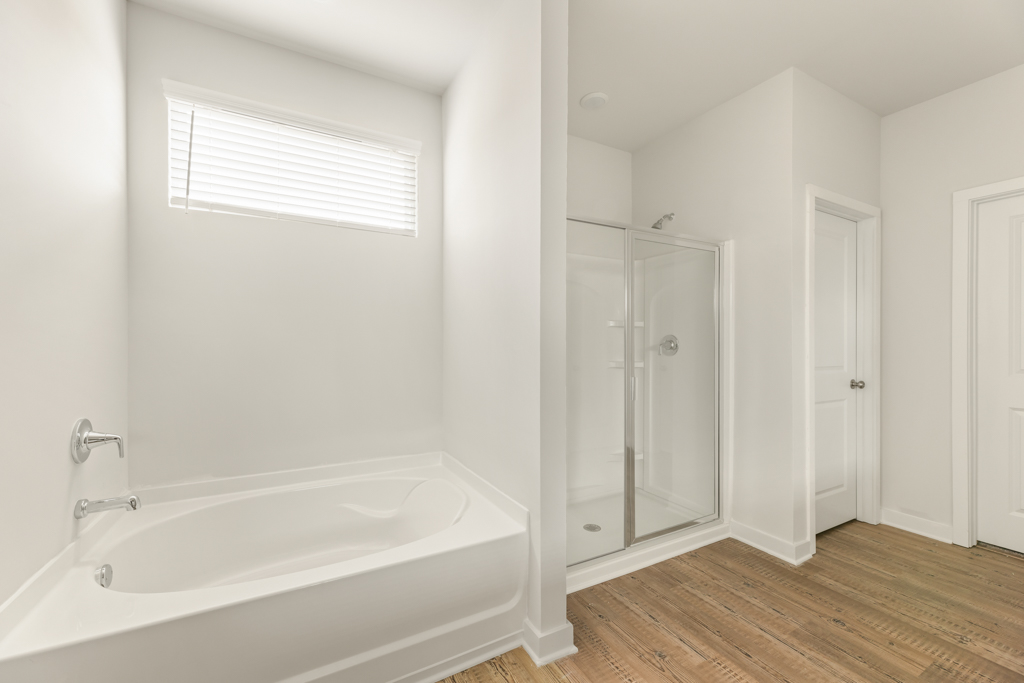 A bathroom with a tub and shower.