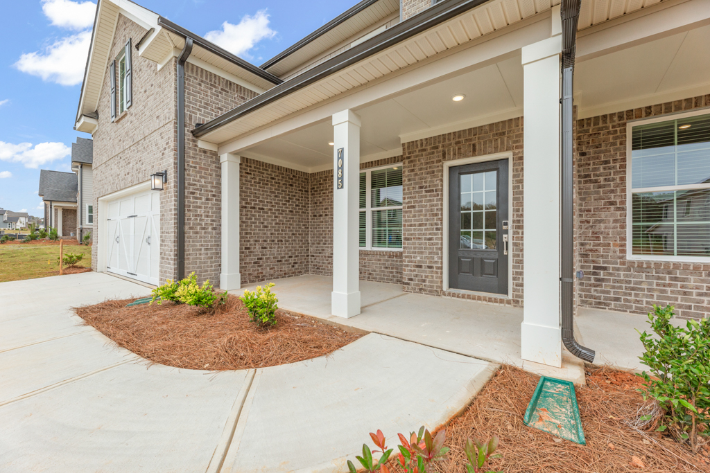 A house with a brick driveway.