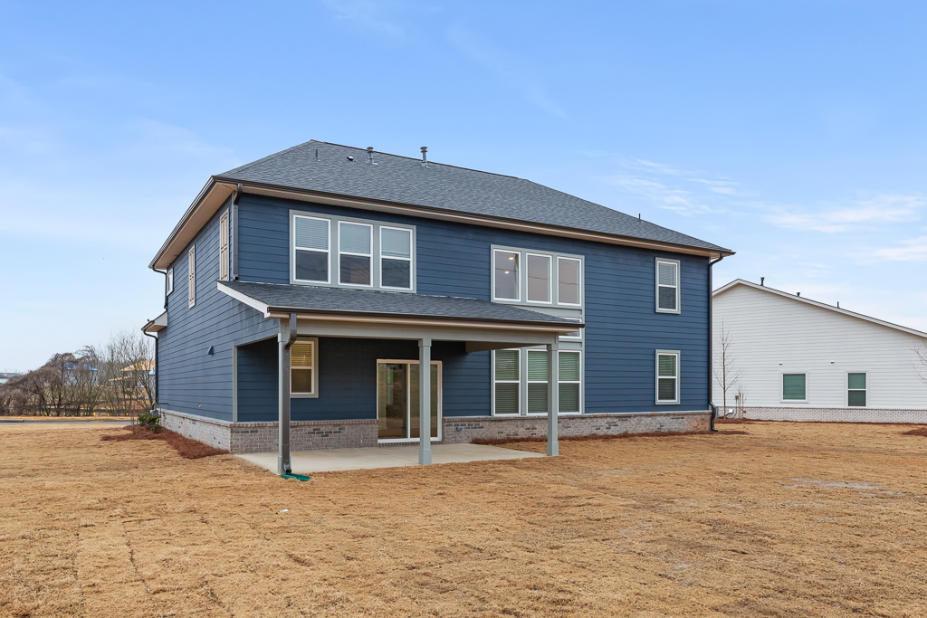 A house with a dirt yard.