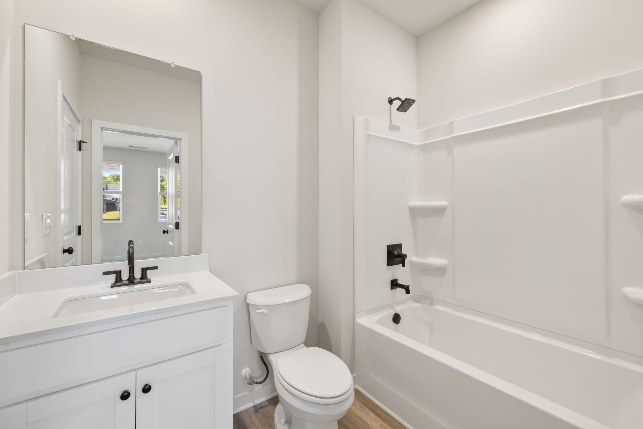 A bathroom with a tub toilet and sink.
