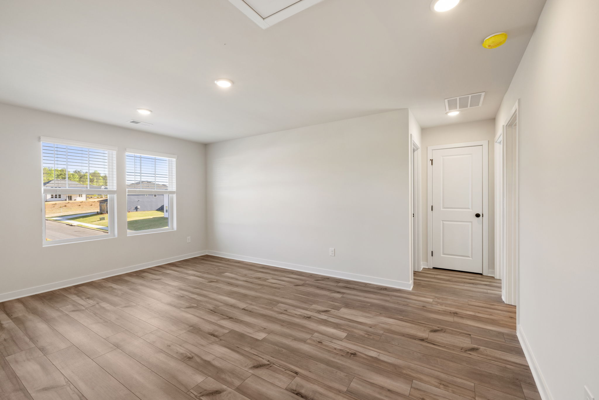 A room with a wood floor and white walls.