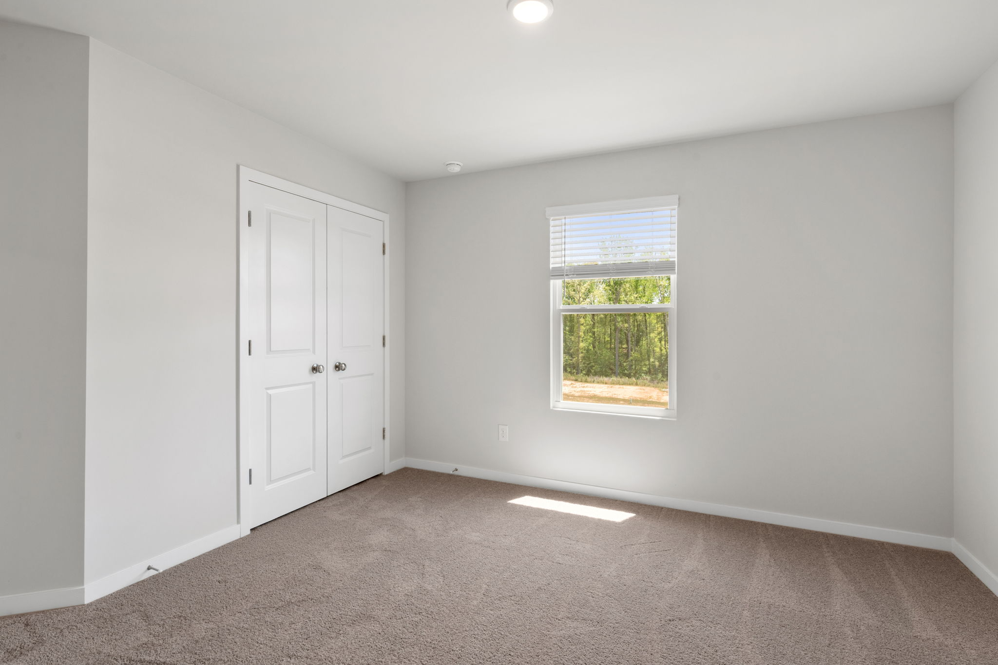 A room with a window and a door.