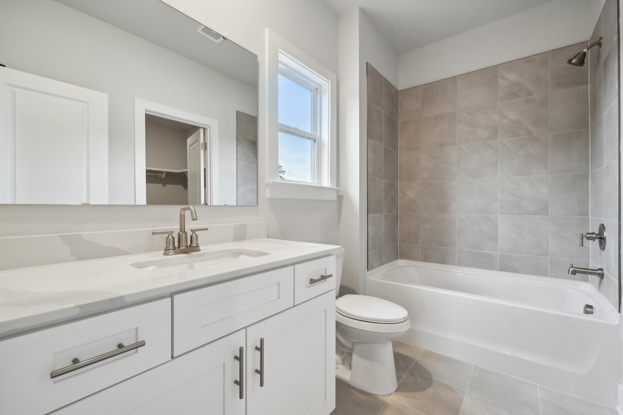 A bathroom with a tub sink and toilet.