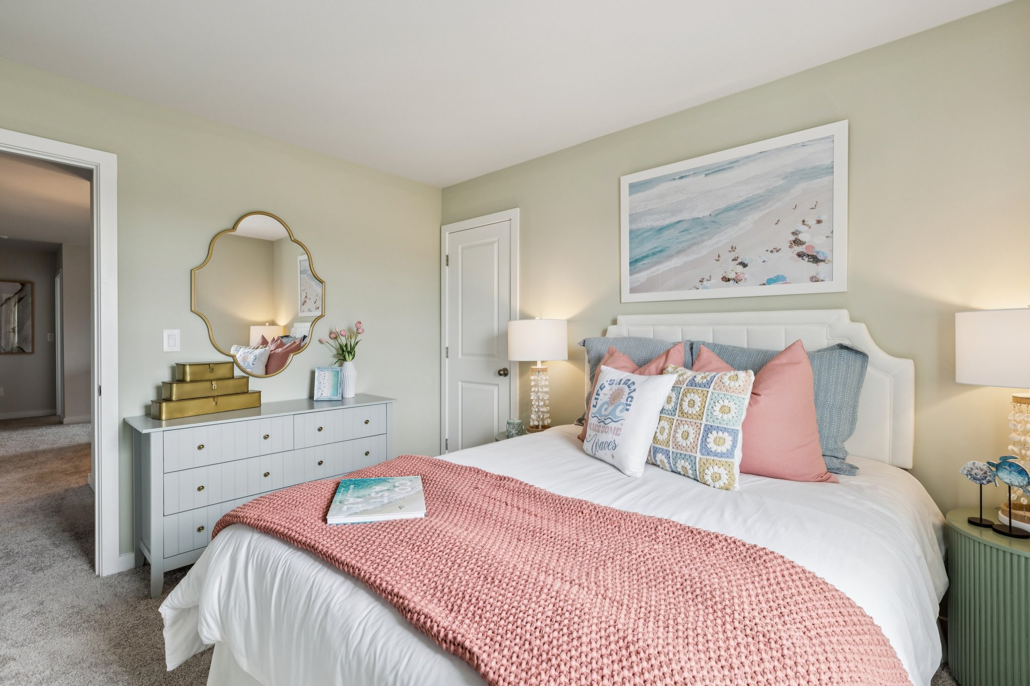 A bedroom with a bed and a mirror.