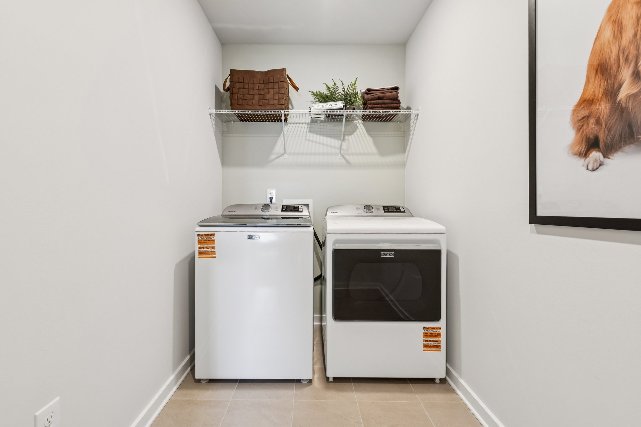 A washing machine and dryer in a room.