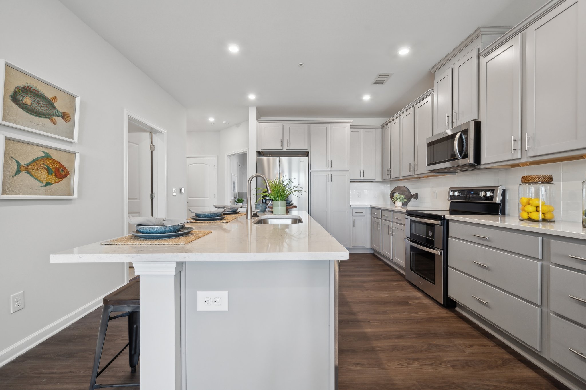 A kitchen with white cabinets.
