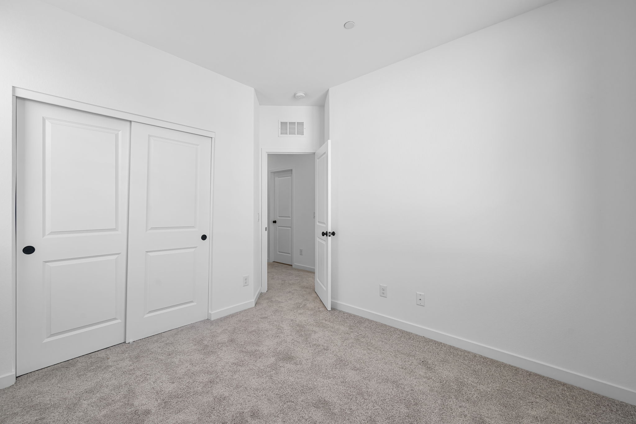 A hallway with white doors.